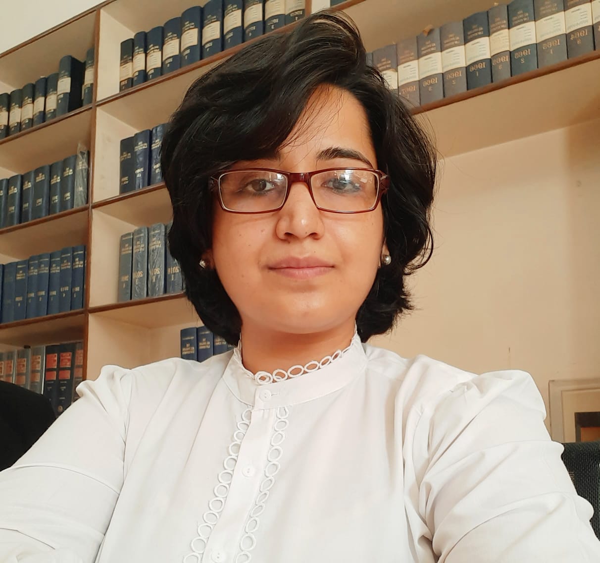 Anjali Goklani, Advocate, in front of law books